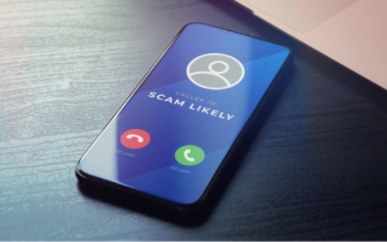 cell phone displaying an incoming call marked "scam likely"