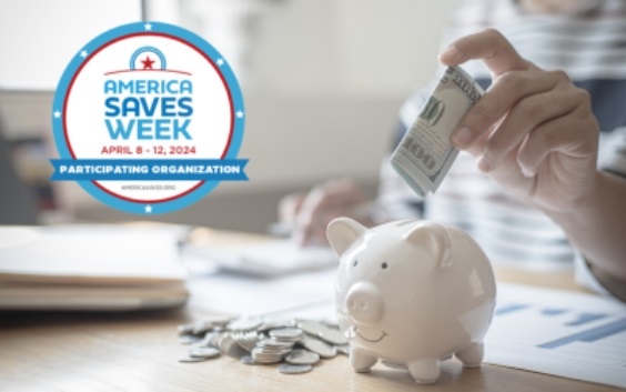 hand putting money in a piggy bank