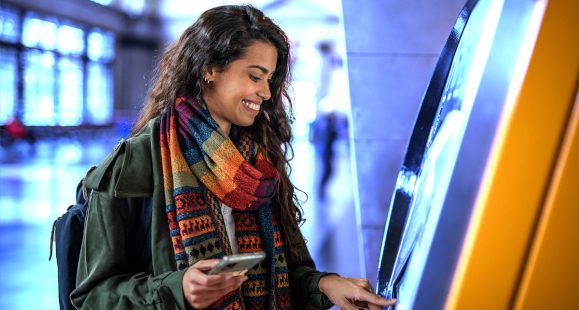 woman doing a transaction at an ATM